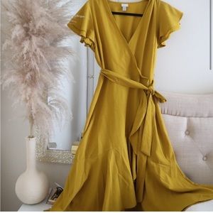 Mustard ruffles detail down the wrap hem dress.